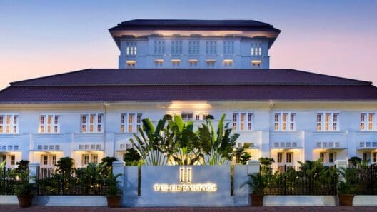 a building with a sign and plants