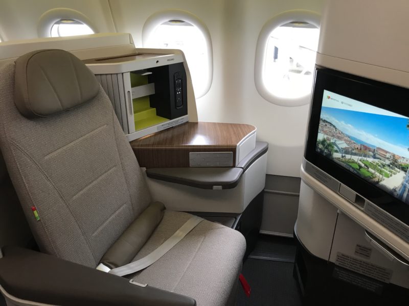 a seat in an airplane with a television and a television