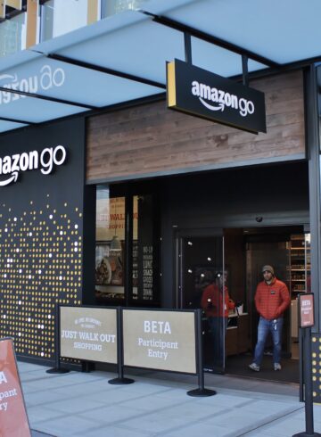a store front with people walking in front of it