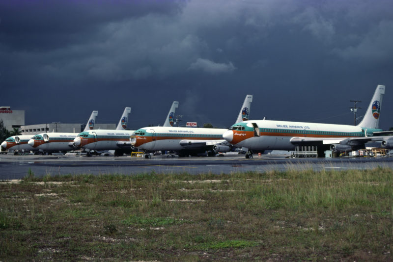 a group of airplanes parked on a runway