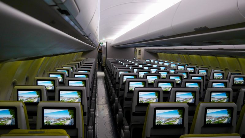 a row of seats with monitors
