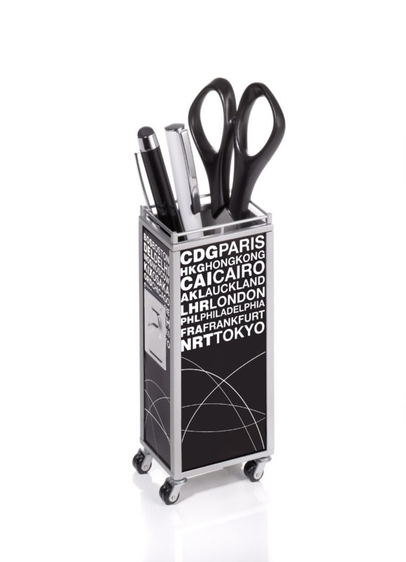 a black and silver pen holder with scissors and pens