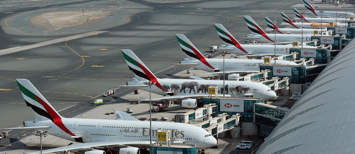 a group of airplanes parked at an airport