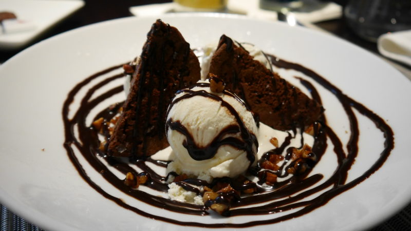 a plate of dessert with ice cream and chocolate sauce