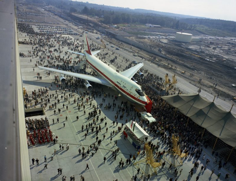 an airplane parked in a large crowd