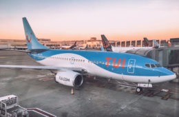 a blue and white airplane parked on a runway