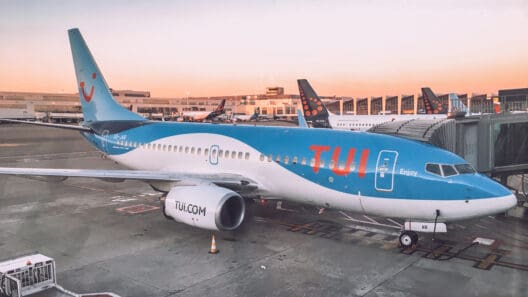 a blue and white airplane parked on a runway