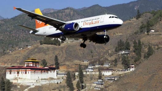 a plane flying over a town
