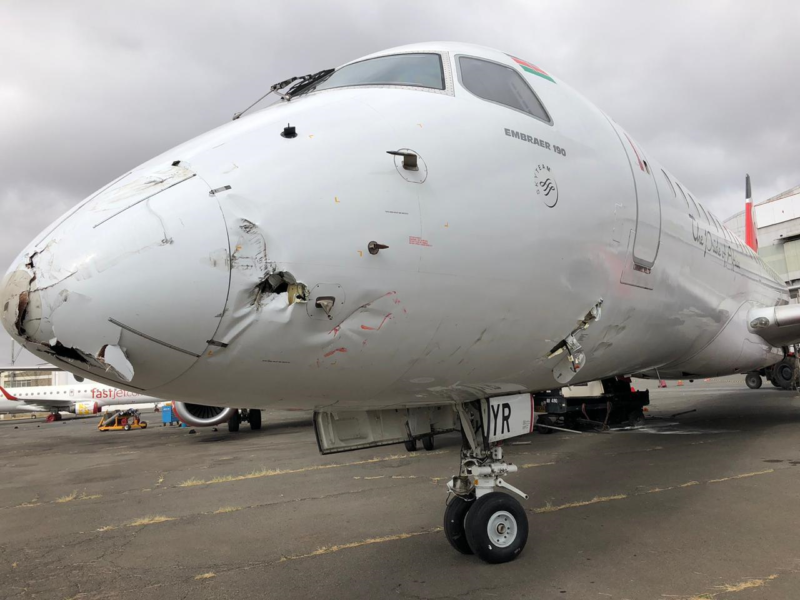 a white airplane with a hole in the front