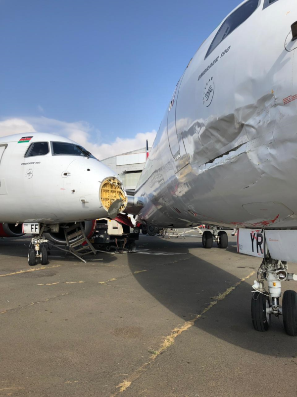 a white airplane with a broken nose