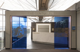 a glass door with a sign and a reception desk