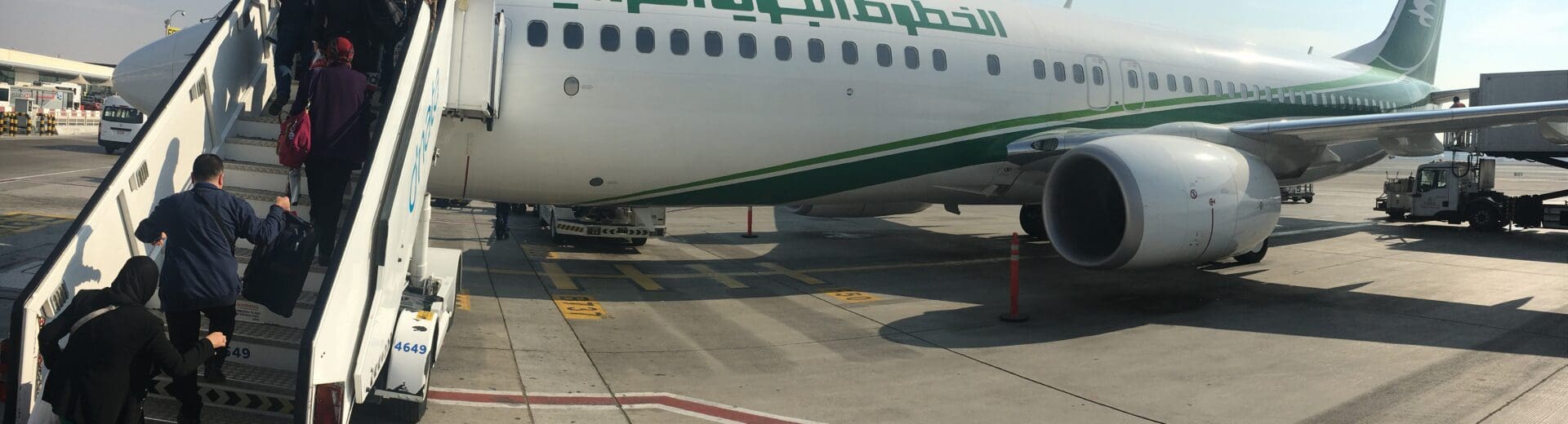 a group of people boarding an airplane
