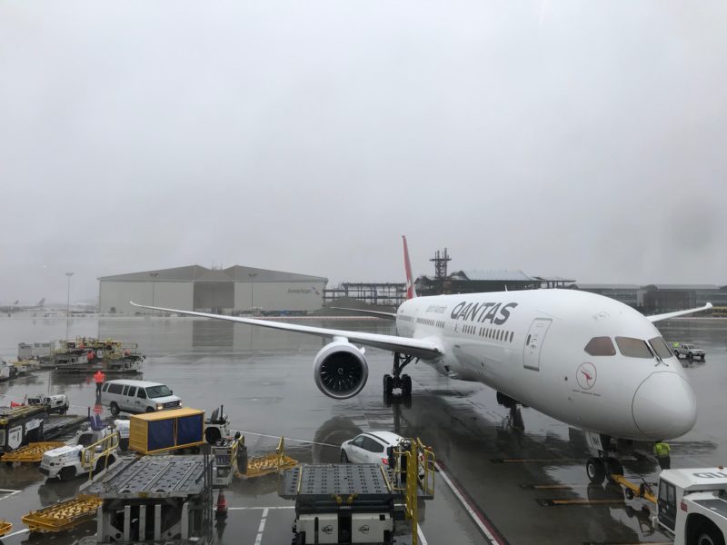 a large white airplane on a wet runway