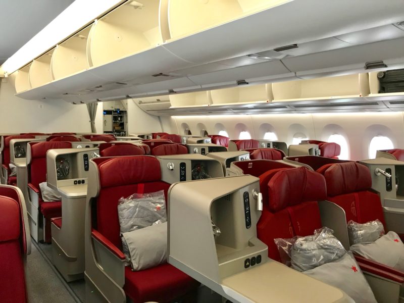 an airplane with red seats and a shelf