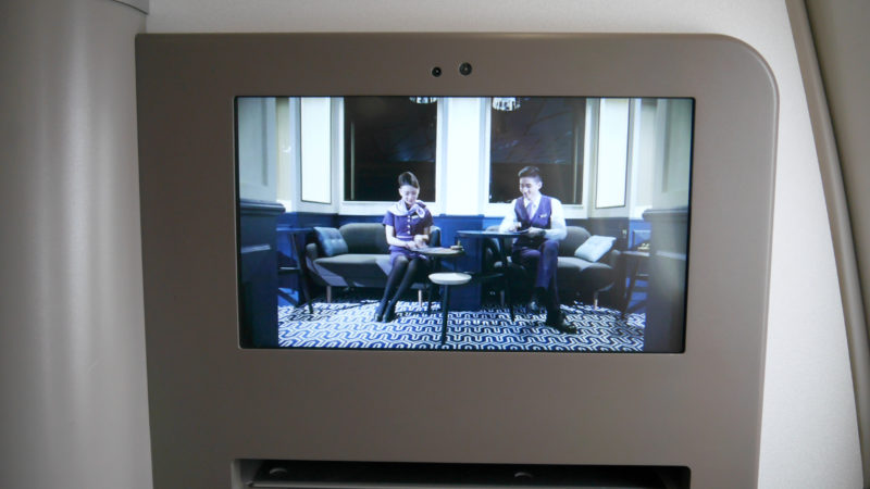 a television screen showing a couple of people sitting at a table