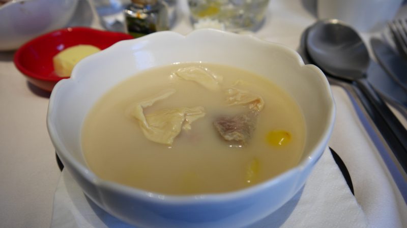 a bowl of soup with meat in it
