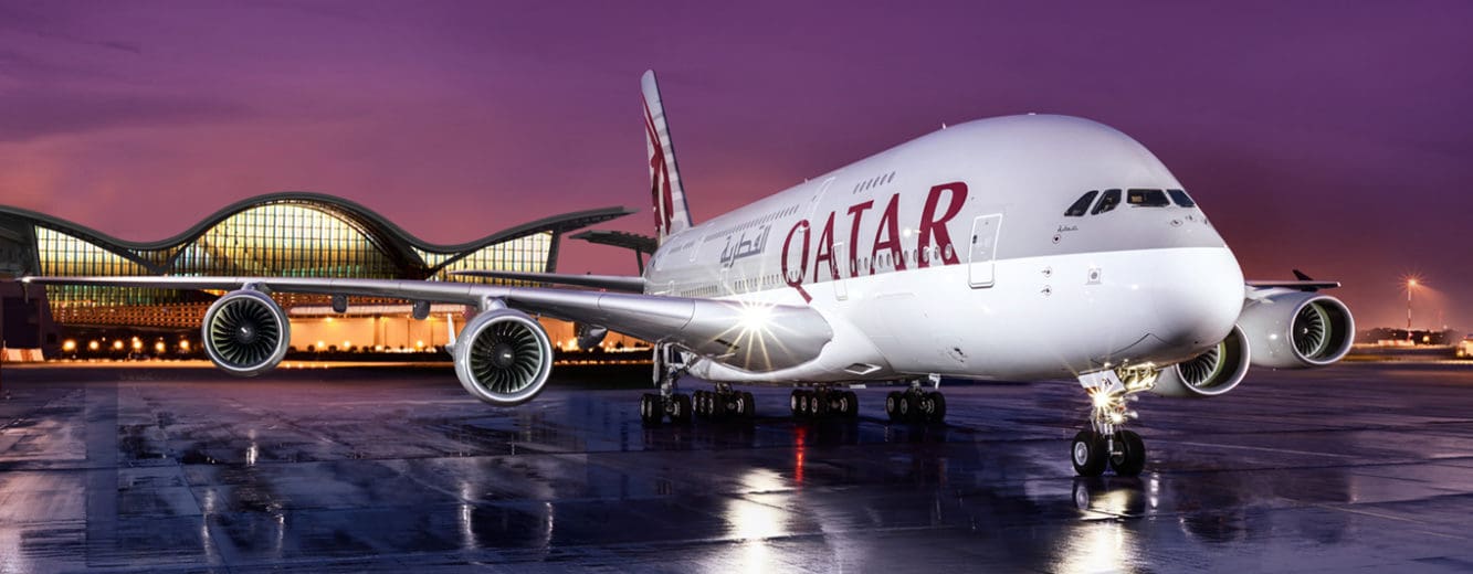 a large white airplane on a wet runway