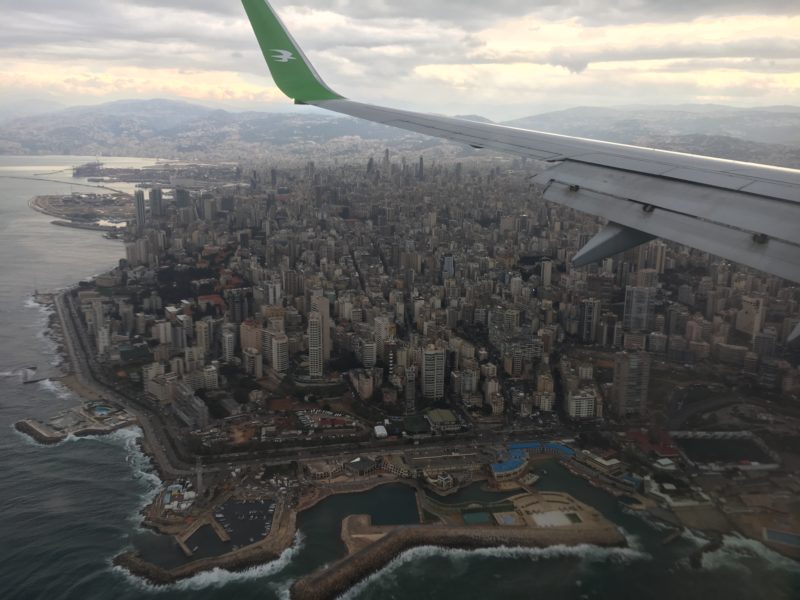 an airplane wing and city view