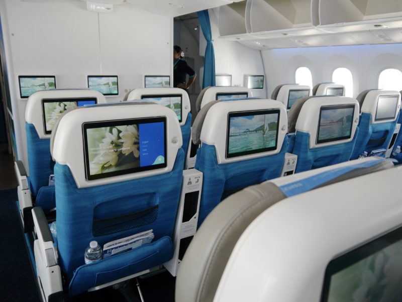 a row of seats with monitors on them