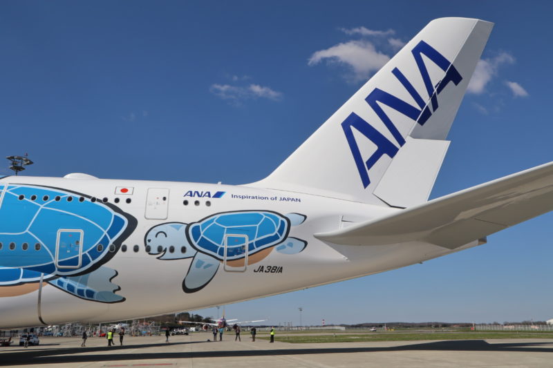 a white airplane with blue and white designs on it