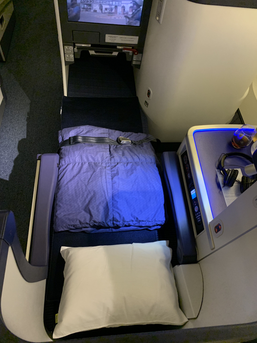 a bed and pillow in a plane