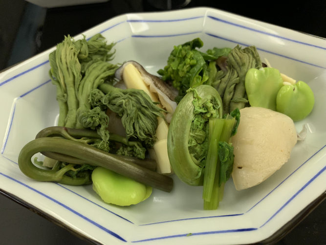 a plate of vegetables on a black surface