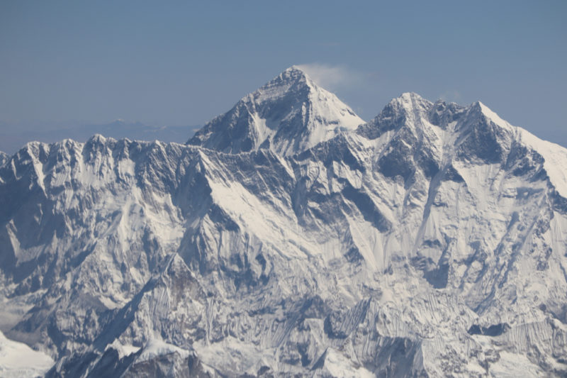 a snowy mountain range with blue sky