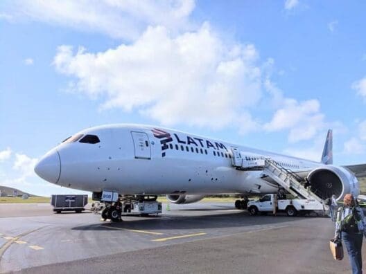 a white airplane with a staircase on the ground