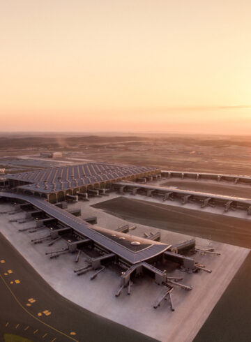 an airport with a large building and runway