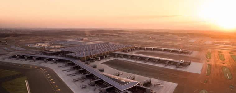 an airport with a large building and runway