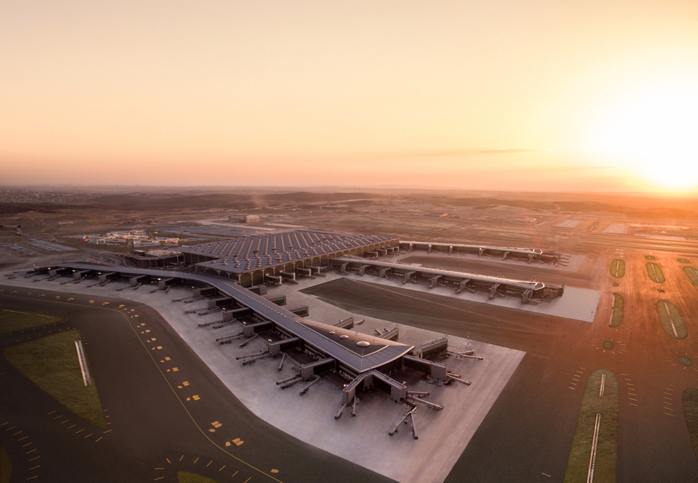 an airport with a large building and runway