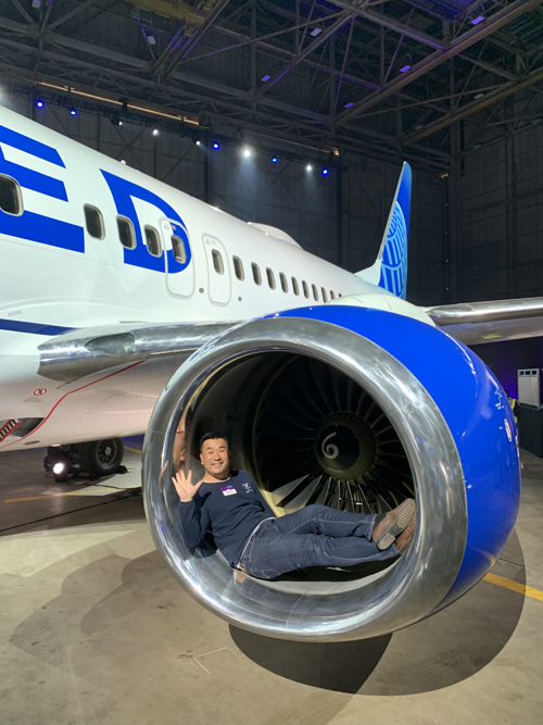 a man lying in a jet engine