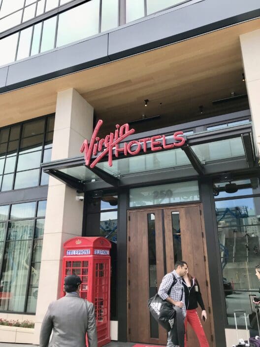 a man walking in front of a hotel