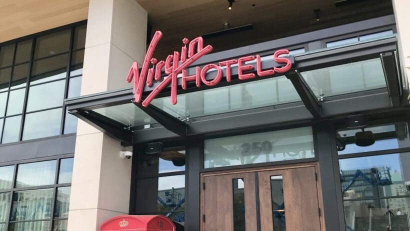a man walking in front of a hotel