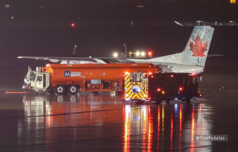 a firetrucks and a plane at night