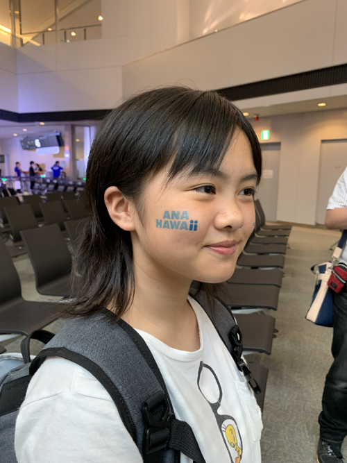 a girl with blue writing on her face