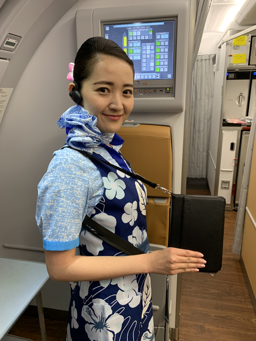 a woman wearing a blue and white floral shirt and headphones