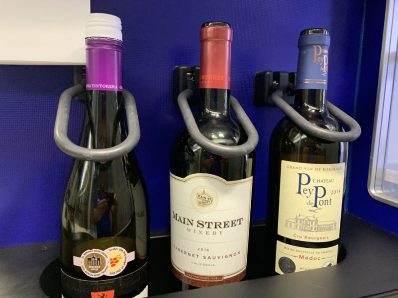 a group of wine bottles on a shelf