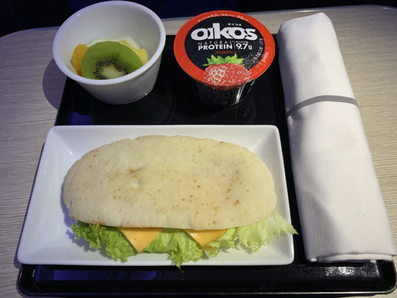 a sandwich and yogurt on a tray
