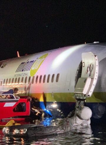 Boeing 737 slides off runway into river