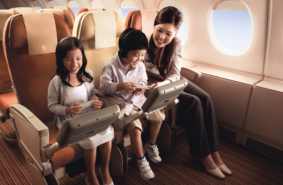 a woman and children sitting on an airplane