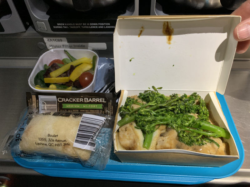 food in a container on a blue tray