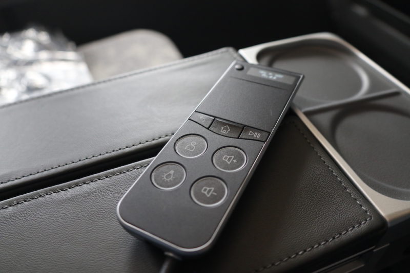a remote control on a leather surface