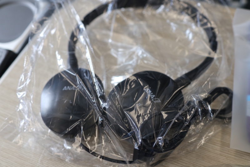 a black headphones wrapped in plastic
