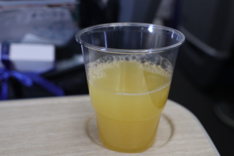 a plastic cup with a yellow liquid in it