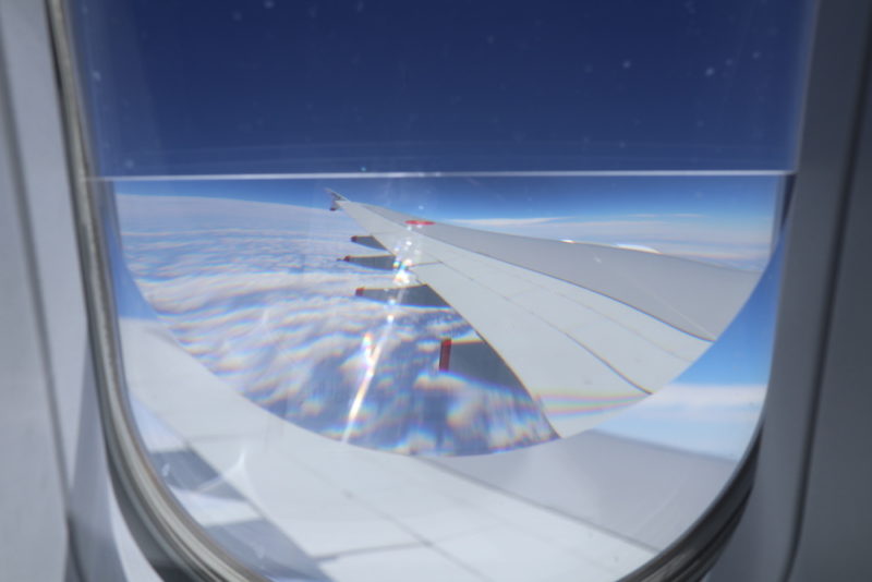 a wing of an airplane seen through a lens