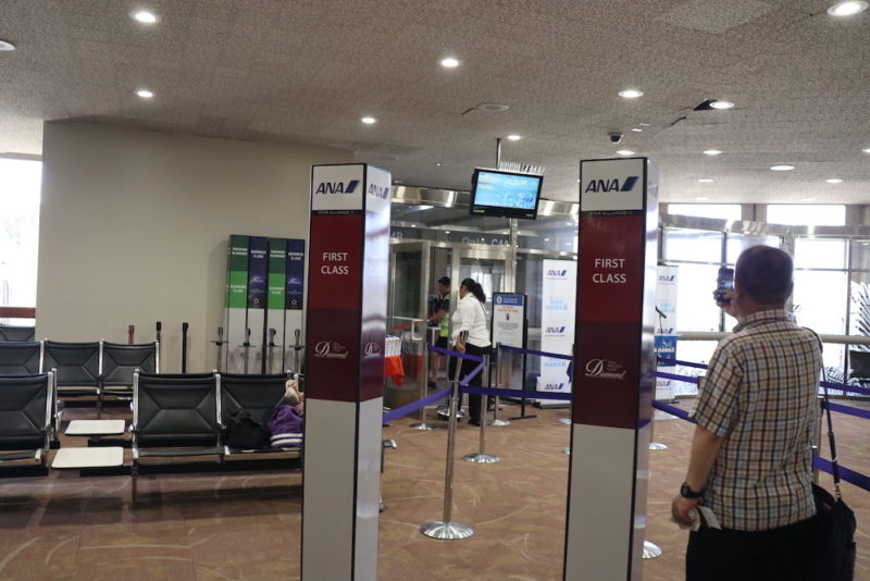 people standing in a line in an airport