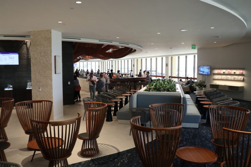 a group of people in a room with chairs and tables