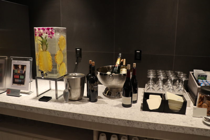 a bar counter with wine glasses and bottles