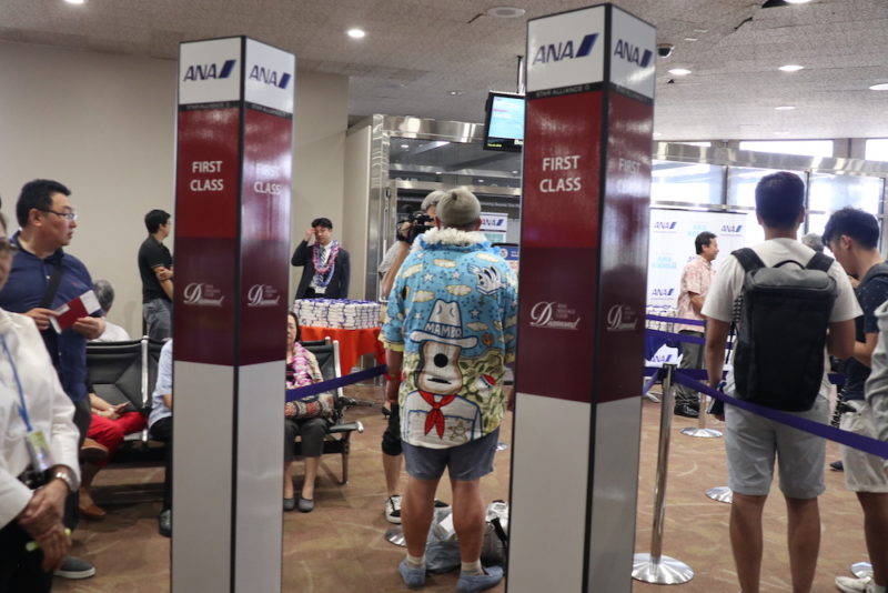 people standing in a line at an airport